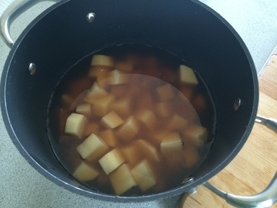 Potatoes and broth in pot